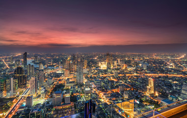 Fototapeta na wymiar Cityscape of light traffic with skyscraper and Chao Phraya river at Bangkok metropolis