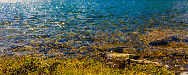 Fototapeta na wymiar Lake water and stone shore