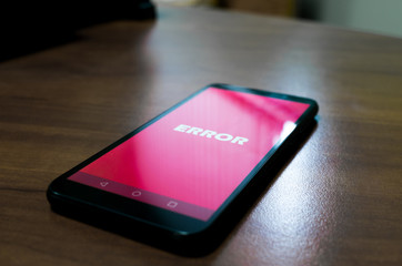 Black smartphone with error message on the screen