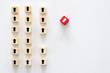 concept of think different, innovation and creativity. red cube changing direction from others.