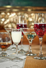 Glass glasses with colored drinks on the table. alcoholic drinks at the buffet