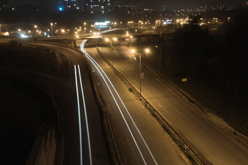 Autumn night light trails at entrance of the city.