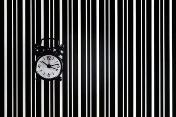 The symbol of the time is the alarm clock on the background of the diffraction bands.