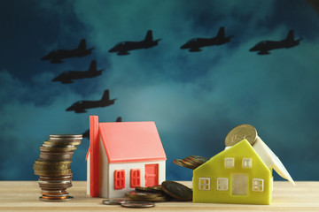 Toy houses under the threat of war, which military aircraft personifies