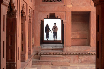 Couple holding hands while visiting a Fatehpur Sikri, Uttar Pradesh.