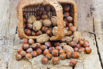 nuts in a basket on old wooden background