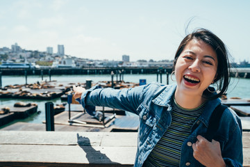 woman cheerfully pointing showing resting seals