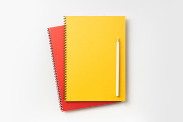 Top view of yellow and red spiral notebook
