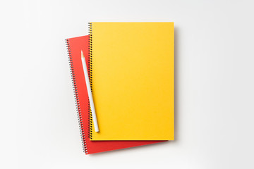Top view of yellow and red spiral notebook