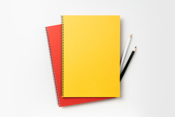 Top view of yellow and red spiral notebook