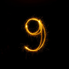 Numbers 0 to 9 created using a sparkler on black