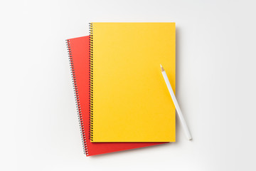 Top view of yellow and red spiral notebook