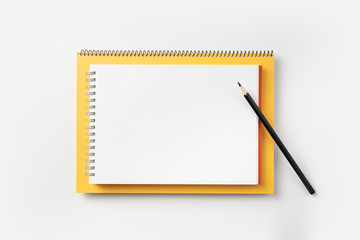 Top view of yellow and red spiral notebook