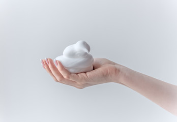 white bubbled foam in hands, hair foam, foam for man, white textured, hand full of soap isolated on...