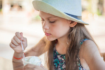 Little and cute girl eating ice cream