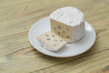 Blue cheese cut on a plate.