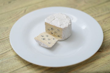 Blue cheese cut on a plate.
