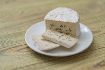 Blue cheese cut on a plate.