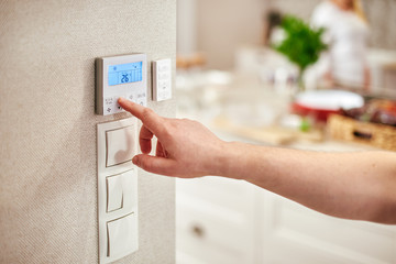 Digital Thermostat and male hand