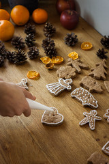 Christmas gingerbread icing decorating process. Homemade sweet cookies