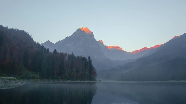 Peaceful autumn view on Obersee lake in Swiss Alps. Clear sky and mountains reflections in clear water. Nafels village, Switzerland. Timelapse video