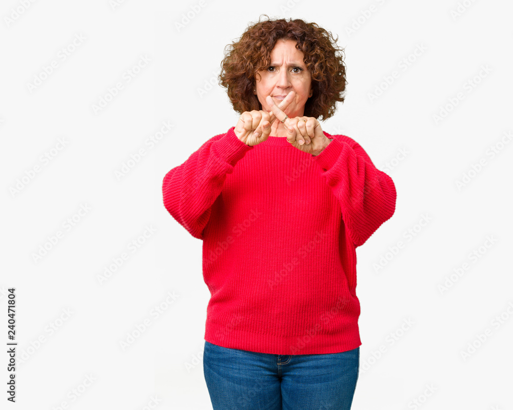 Wall mural beautiful middle ager senior woman red winter sweater over isolated background rejection expression 