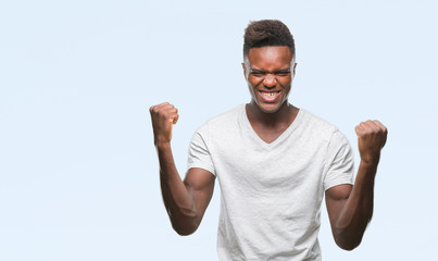 Young african american man over isolated background celebrating surprised and amazed for success with arms raised and open eyes. Winner concept.