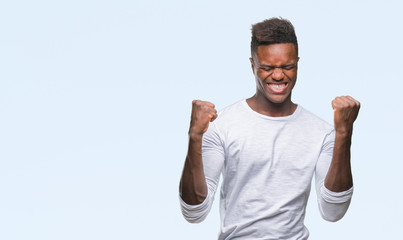Young african american man over isolated background very happy and excited doing winner gesture with arms raised, smiling and screaming for success. Celebration concept.