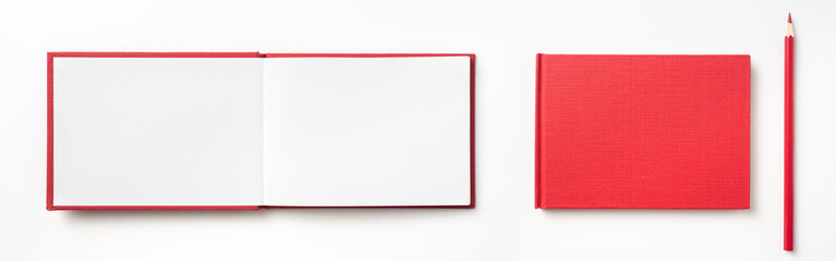 Top view of red hardcover notebook and pencil