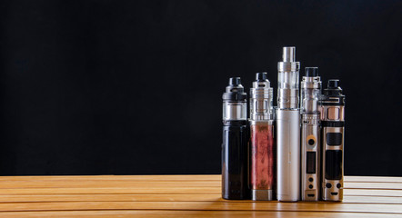 Popular vaping e cig devices mod.electronic cigarette over a black background. vaporizer e-cig old...