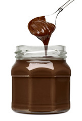 Hazelnut or filberts spread chocolate with spoon in jar isolated on white background 