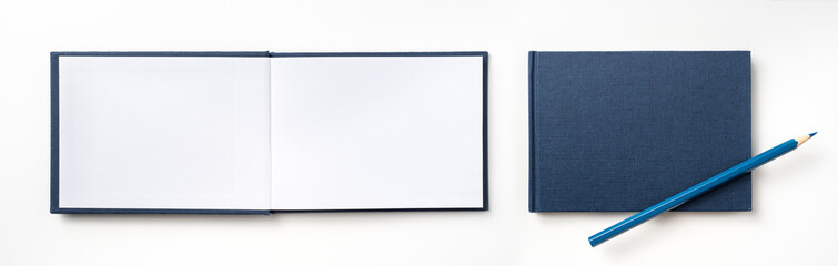Top view of blue hardcover notebook and pencil