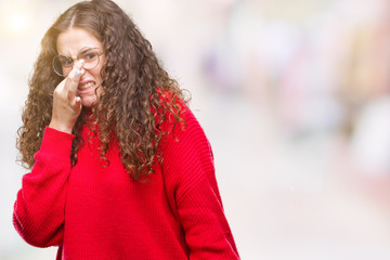 Beautiful brunette curly hair young girl wearing glasses and winter sweater over isolated...