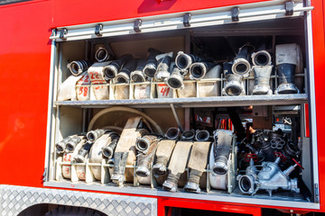 Rescue fire truck equipment. Compartment of the rolled up fire hoses on a fire engine