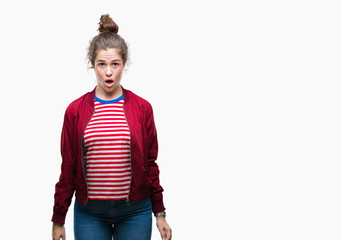 Fototapeta premium Beautiful brunette curly hair young girl wearing a jacket over isolated background afraid and shocked with surprise expression, fear and excited face.