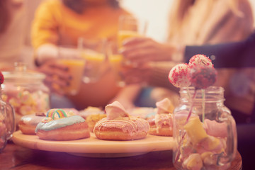 Pregnant woman celebrating baby shower party with friends.