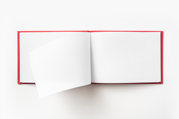 Top view of red notebook with open page
