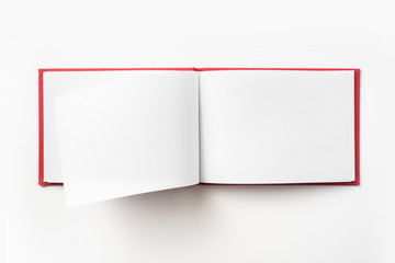 Top view of red notebook with open page