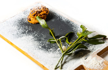 mistletoe and cookies on dark board close up