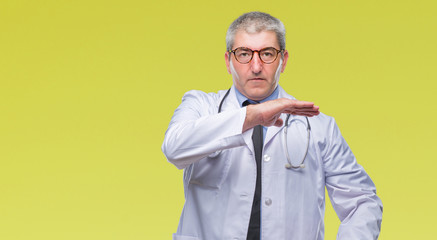 Handsome senior doctor man over isolated background gesturing with hands showing big and large size sign, measure symbol. Smiling looking at the camera. Measuring concept.