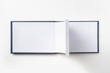 Top view of blue notebook with open page