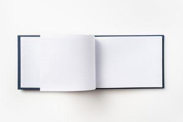 Top view of blue notebook with open page