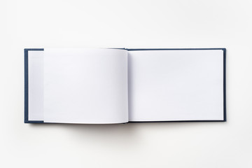 Top view of blue notebook with open page