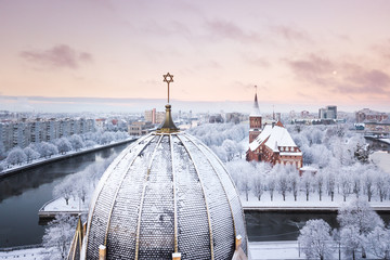 The tower of synagogue on the background of Cathedral in Kaliningrad in winter - obrazy, fototapety, plakaty