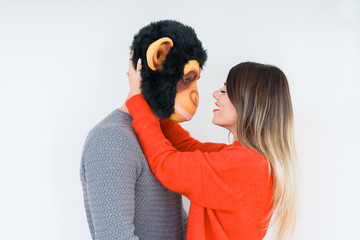Funny young couple, boyfriend wearing monkey mask, crazy and idiot relationship in love