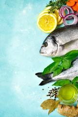 Uncooked organic dorado or sea bream with ingrediets for making.Top view with copy space.