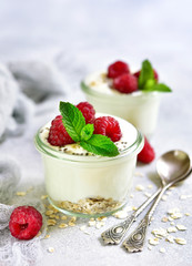 Two portions of homemade natural yogurt with oats,chia seed and fresh berries.Concept of healthy breakfast