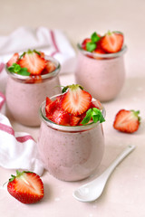 Homemade strawberry mousse in a vintage glass jar.