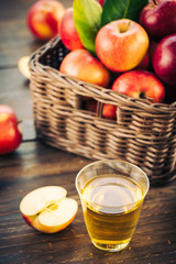 Apples juice in glass with apple in the basket