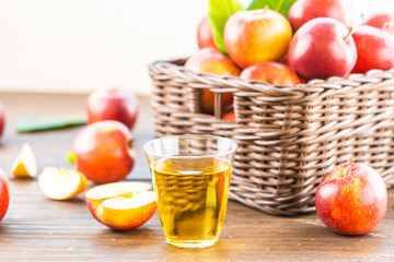 Apples juice in glass with apple in the basket